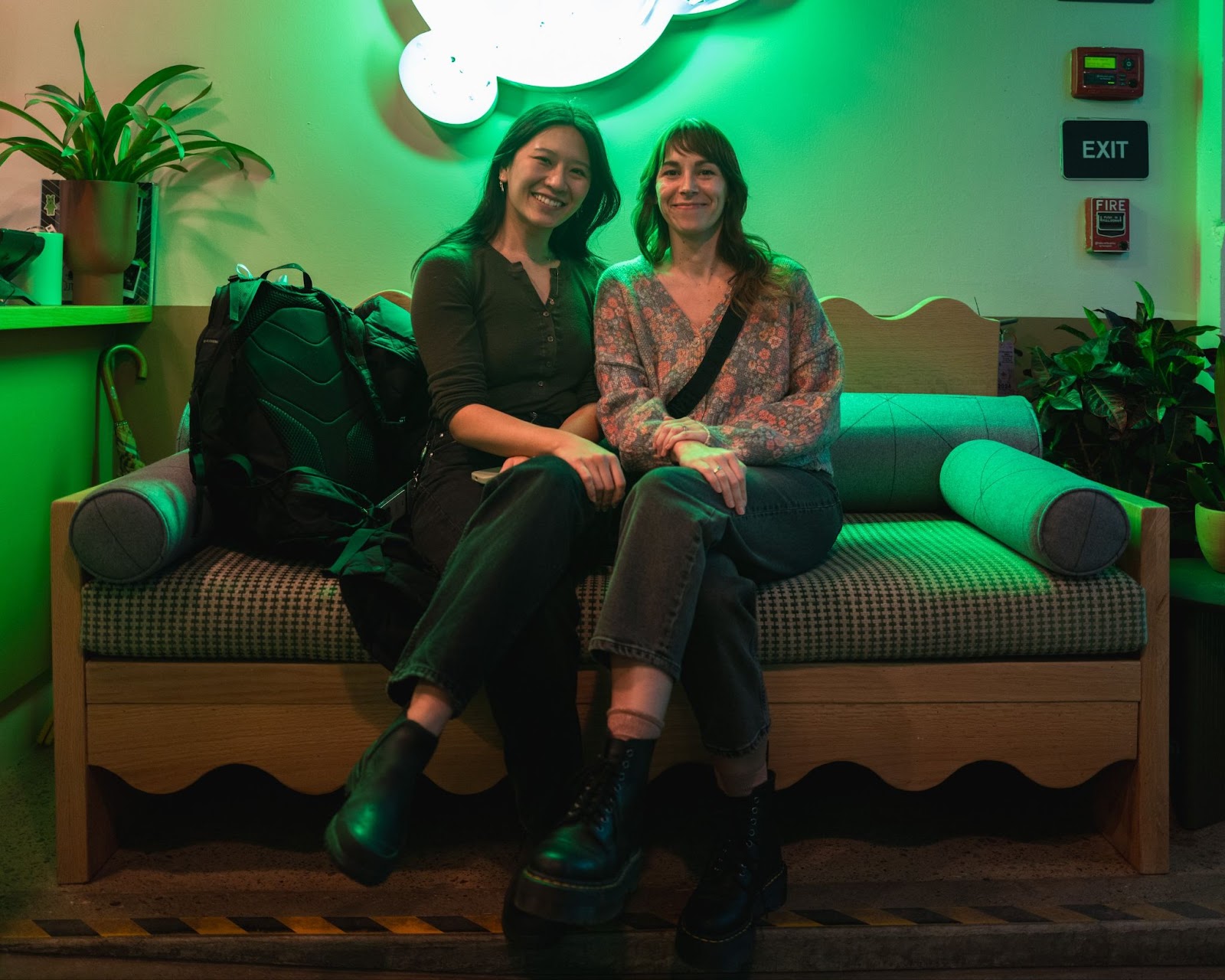 A photo of two women sitting on a bench at Duo's Taqueria. 